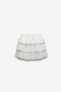 MINI-JUPE À VOLANTS EN BRODERIE ANGLAISE