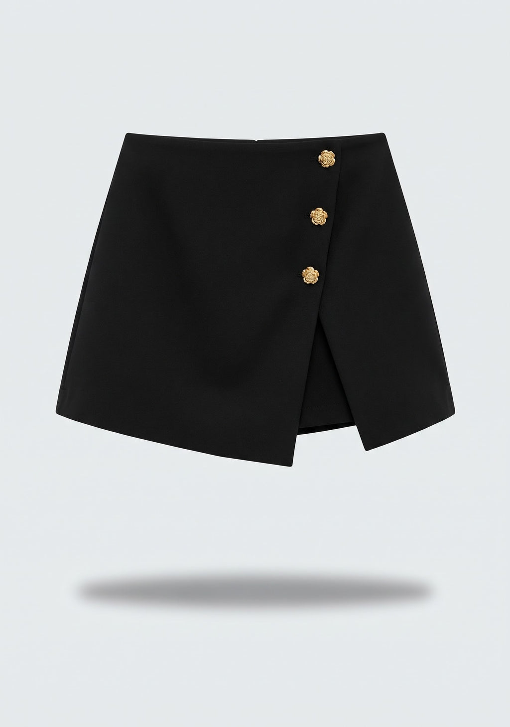 MINI JUPE-SHORT ASYMÉTRIQUE À BOUTONS MÉTALLIQUES