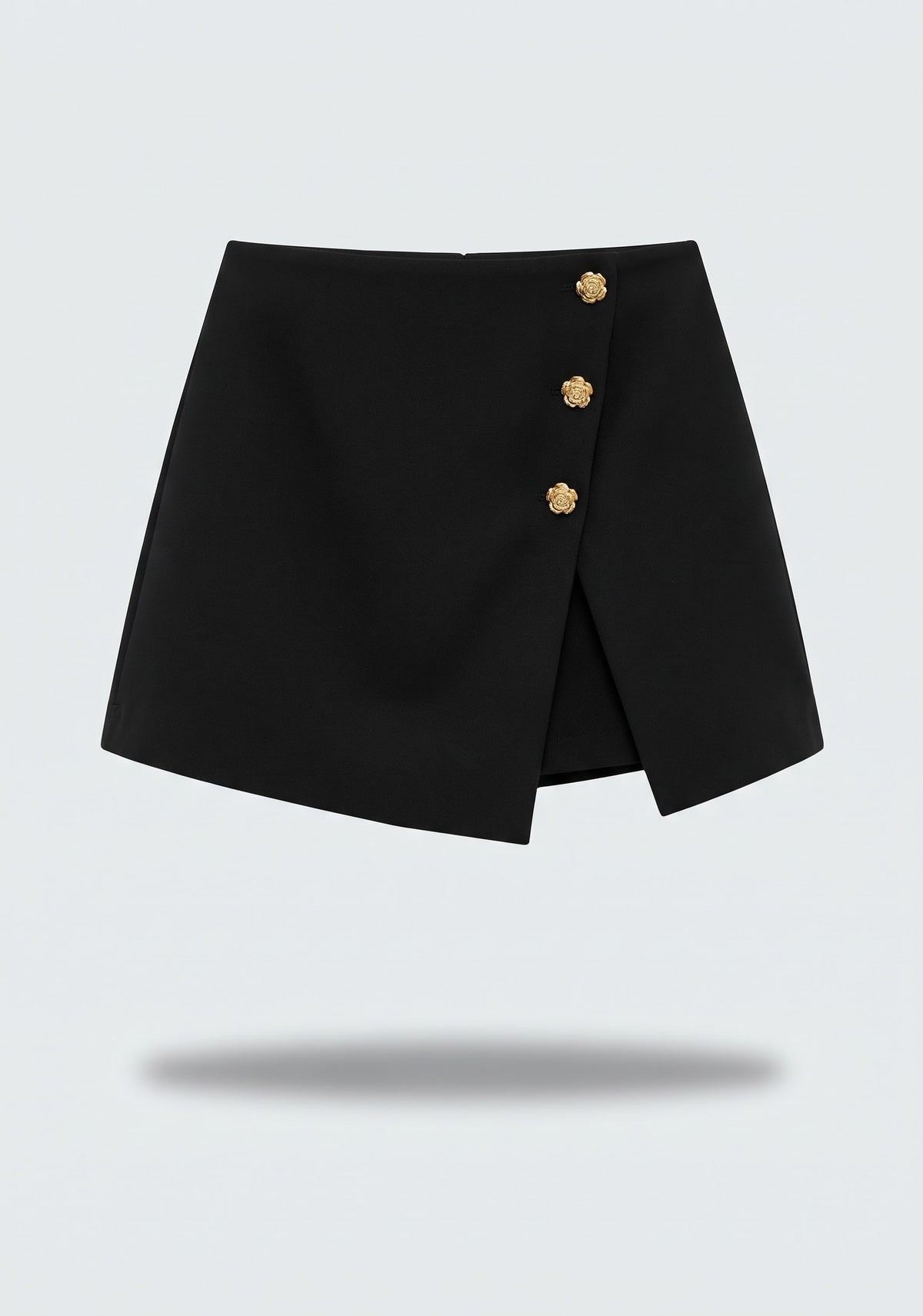 MINI JUPE-SHORT ASYMÉTRIQUE À BOUTONS MÉTALLIQUES