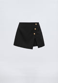 MINI JUPE-SHORT ASYMÉTRIQUE À BOUTONS MÉTALLIQUES